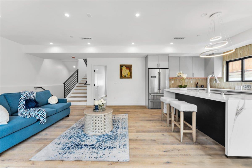 Open concept living room and kitchen design with blue sofa for home staging in San Diego, CA